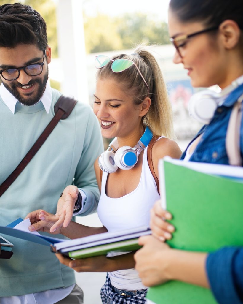 happy-young-university-students-friends-studying-with-books-at-university.jpg